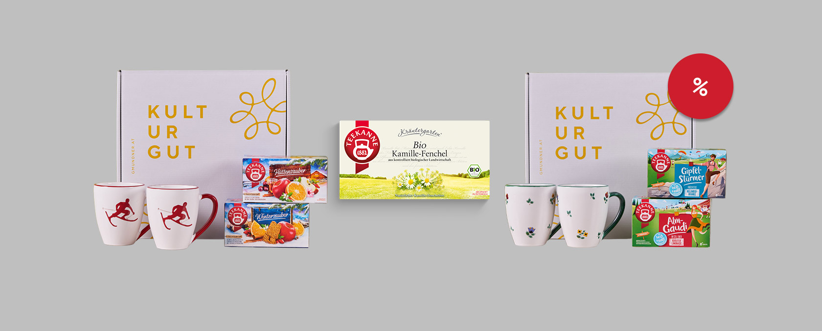 Zwei Kultur Gut-Geschenkboxen mit Tassen und Tee, Kamillentee-Box, rotes Rabattzeichen, hellgrauer Hintergrund.